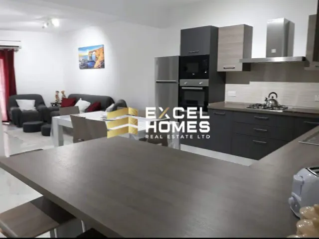a kitchen with a large refrigerator and a table