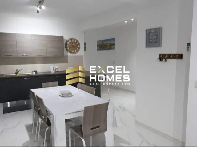 a kitchen with a table and a refrigerator