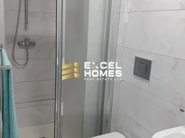a shower stall with a glass door and a shower curtain