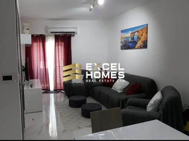 a living room with a couch, coffee table, and a television