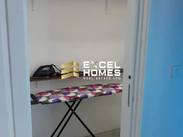 a room with a blue wall and a blue chair