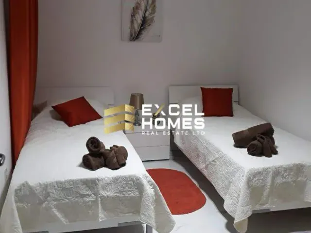 a bed with two pillows and a nightstand