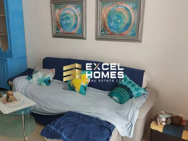 a living room with a couch, a chair, and a bookcase