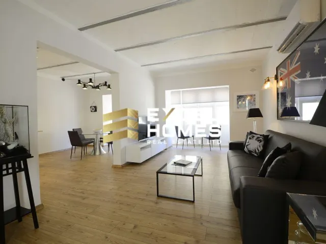 a living room with a couch, coffee table and a television 