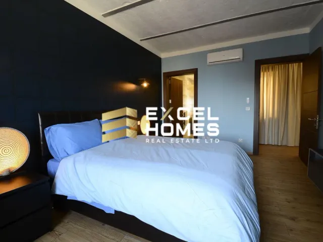 a bed with a white bedspread and a blue comforter 