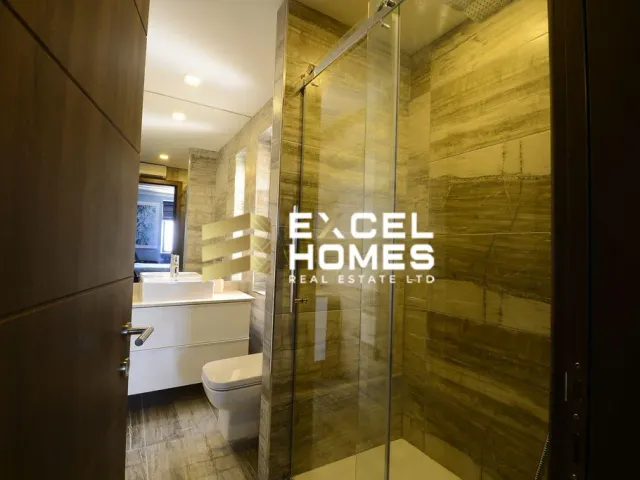 a bathroom with a shower stall and a toilet 