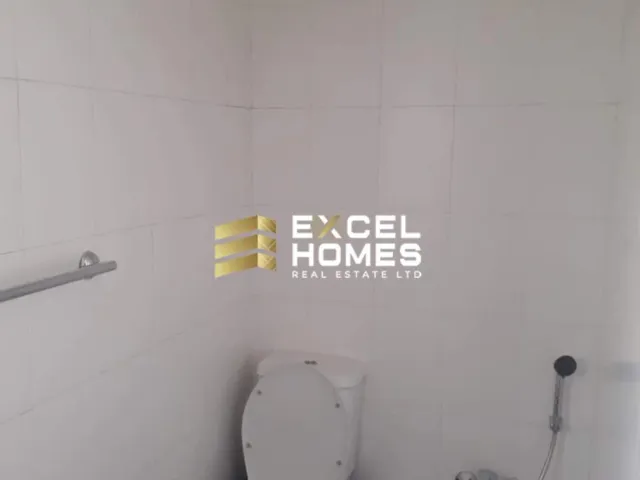 a bathroom with a toilet and a sign