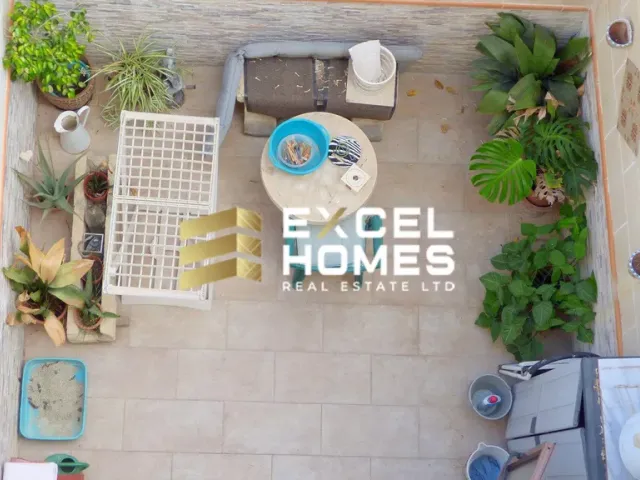 a kitchen with a toilet, chairs, and a table