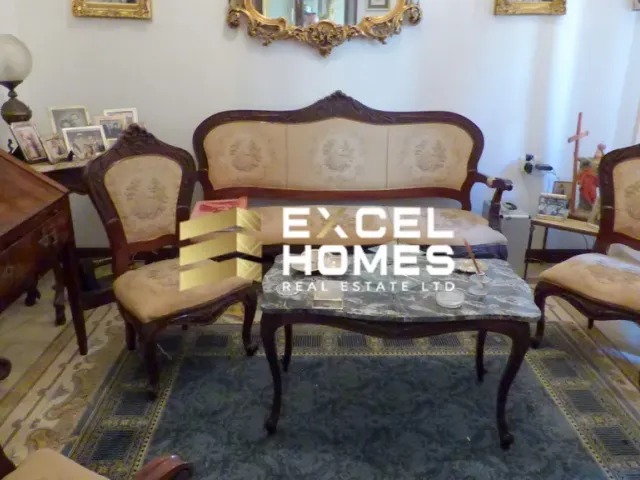 a living room with a table and chairs