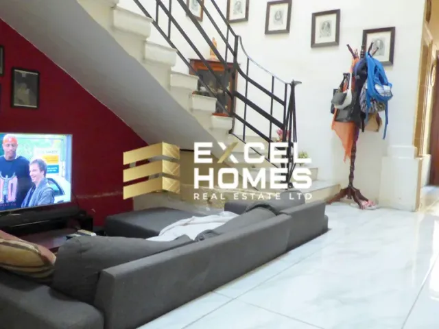 a person is standing on a couch in front of a television