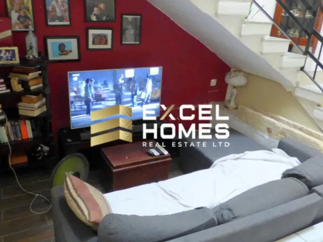 a living room with a couch, chair, and a television