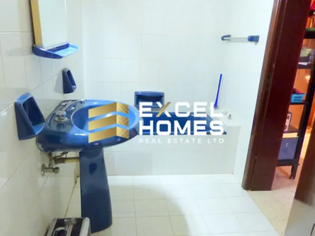 a blue and white toy train on a tile floor