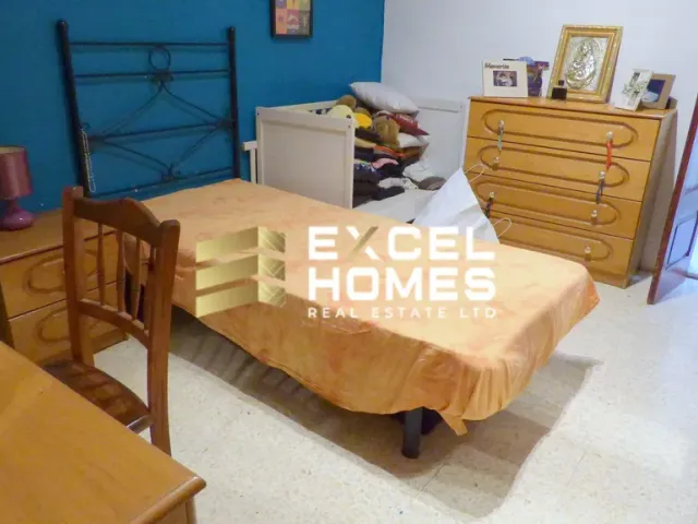 a bed room with a bed and a chair