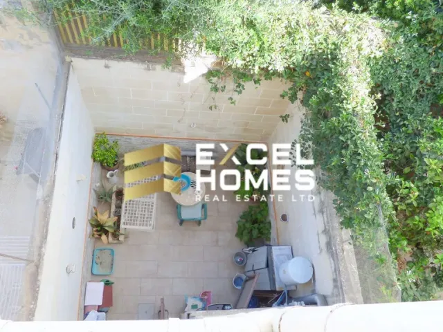 a bathroom with a toilet and a plant