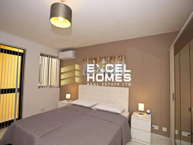 a bedroom with a large bed and a large window