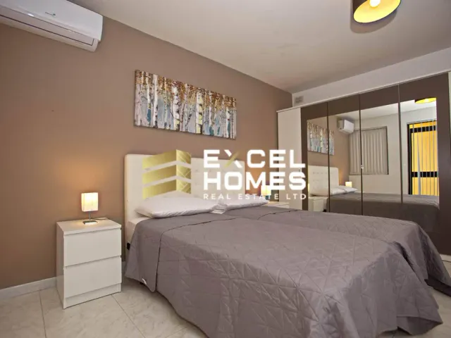 a bedroom with a bed, a dresser, and a lamp