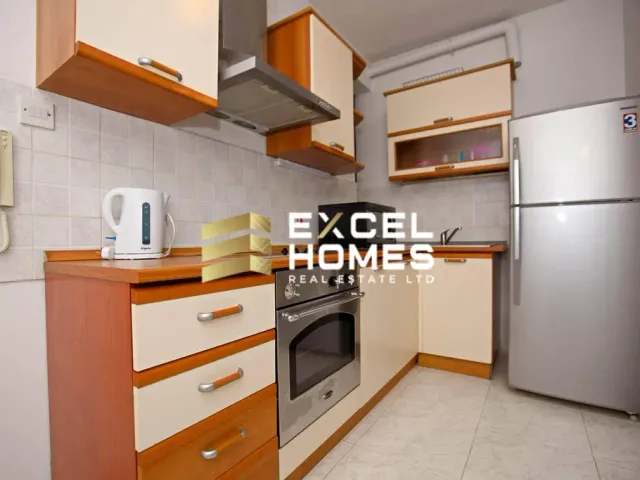 a kitchen with a stove, refrigerator, sink and a microwave