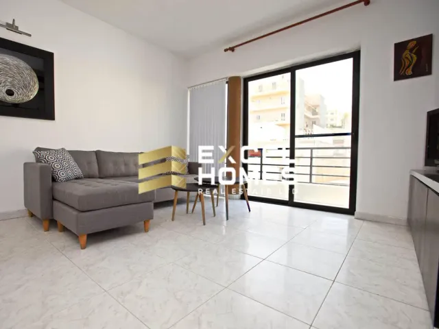 a living room with a couch, table, chairs and a tv