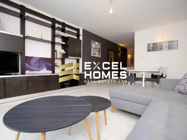 a living room with a couch, chair, and a television