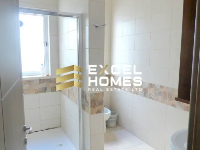 a bathroom with a toilet and a shower stall 