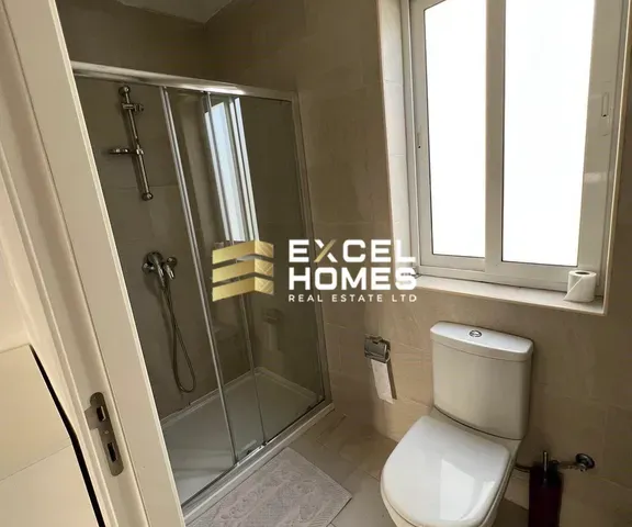 a bathroom with a shower, toilet and sink 