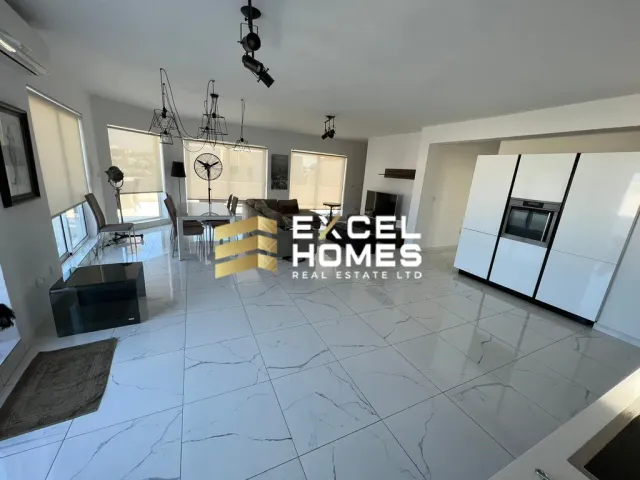 a kitchen with a white refrigerator and a black counter top 
