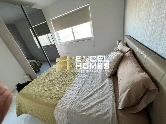 a bed with a blanket and pillows on it 