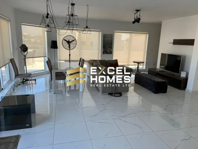 a living room with a couch, chair, and television 
