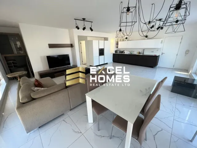 a living room with a couch, table and chairs 