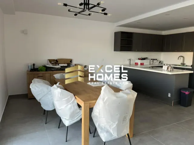 a kitchen with a table and chairs and a refrigerator