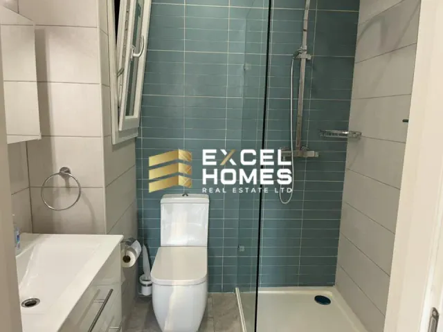 a bathroom with a toilet, sink, and shower
