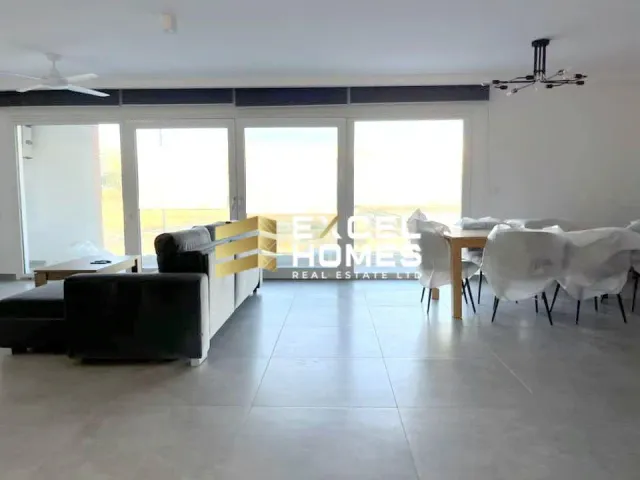 a living room with a table and chairs