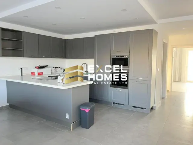 a kitchen with a refrigerator, sink, and a microwave