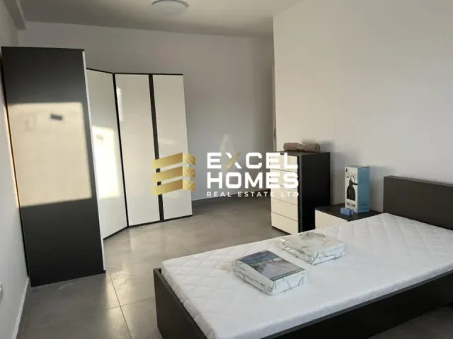 a white bathroom with a white bed and a white wall