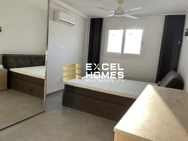 a white bathroom with a white bed and a white wall