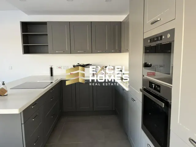 a kitchen with a stove, sink, and refrigerator