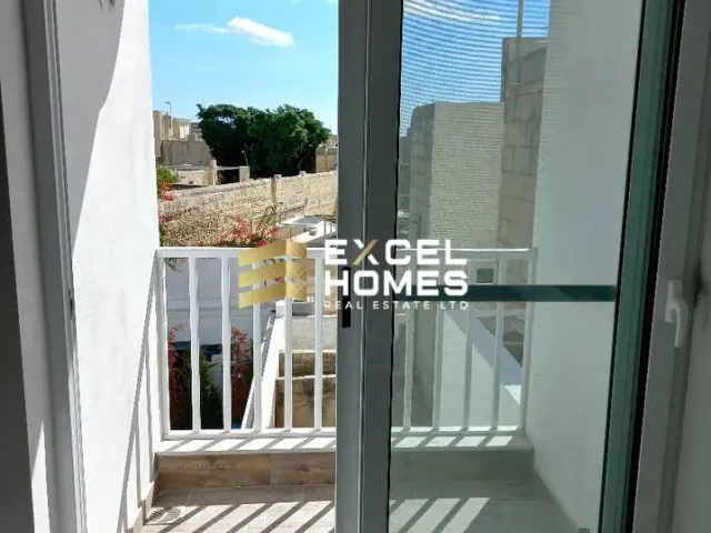 a door is open to a hallway with a view of a building
