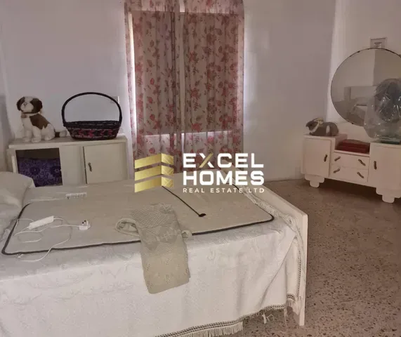 a bedroom with a bed, table, and a mirror