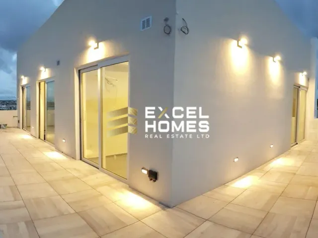 a large white building with a clock on the wall