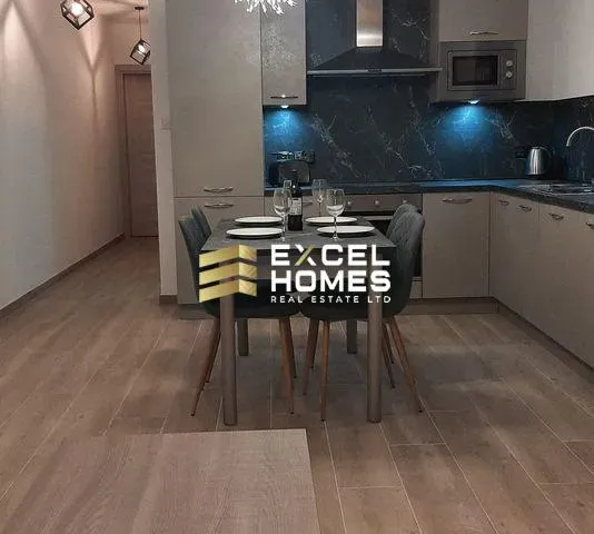 a kitchen with a table and chairs and a refrigerator