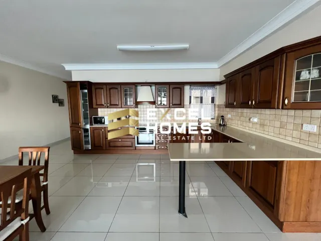 a kitchen with a stove, sink, and refrigerator