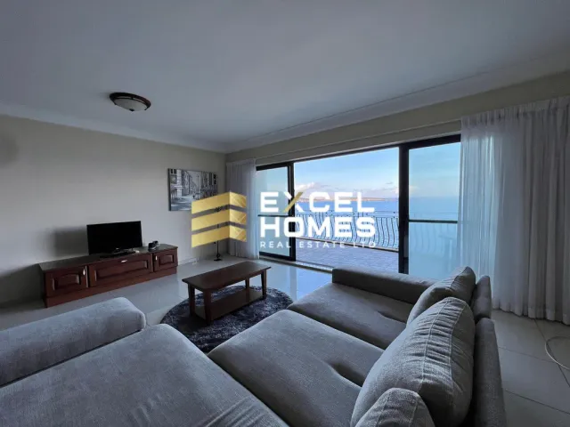 a living room with a couch, chair, and a tv