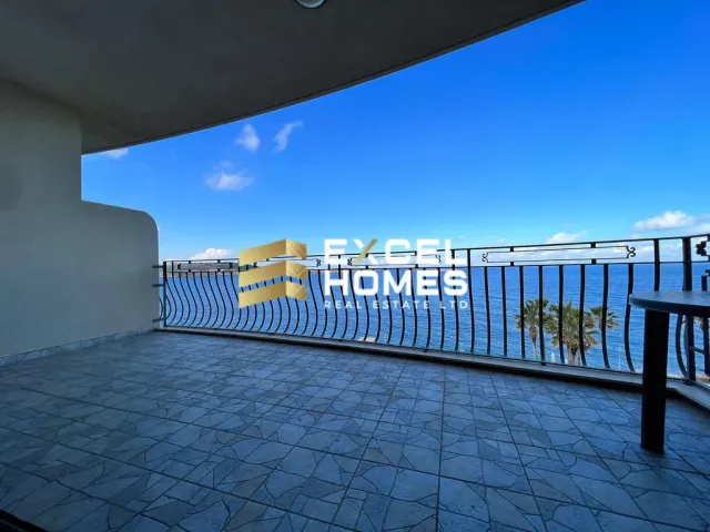 a fence with a view of a beach