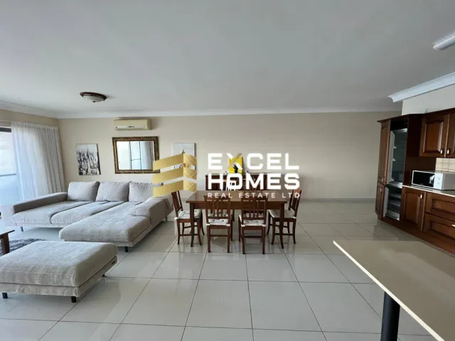 a living room with a table and chairs
