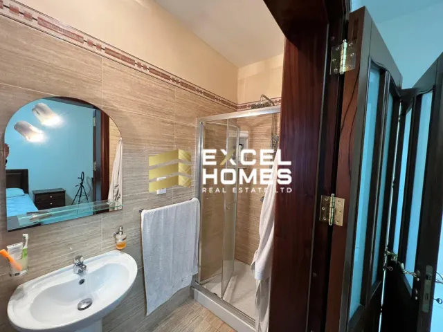 a bathroom with a sink, mirror, and bathtub