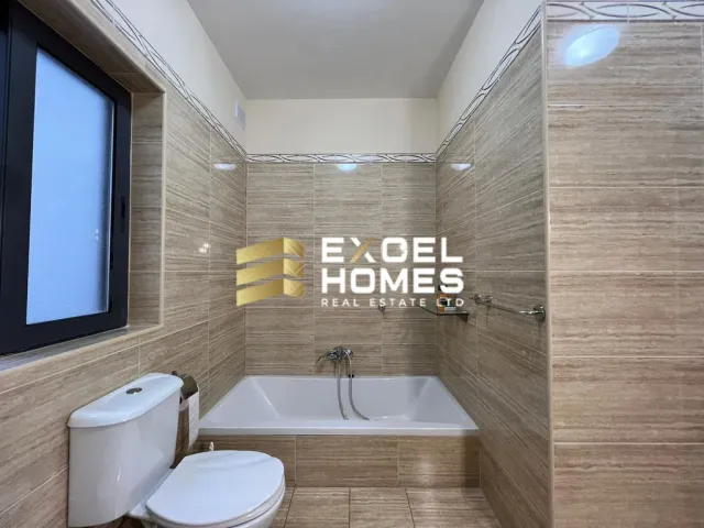 a bathroom with a toilet, sink, and mirror