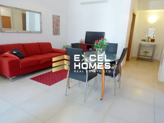 a living room with a couch, coffee table and a television