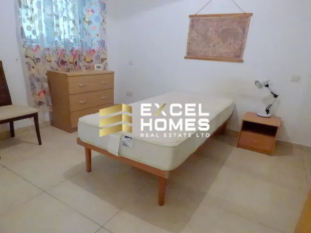 a bed in a room with a white bedspread
