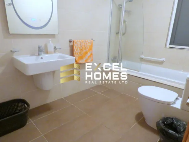a bathroom with a toilet, sink, and shower