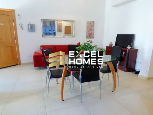 a living room with a couch, chair, and a table